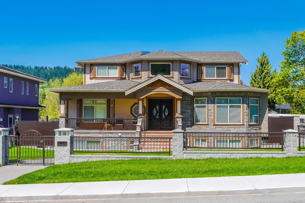 New double-storey family home with front porch and fenced garden